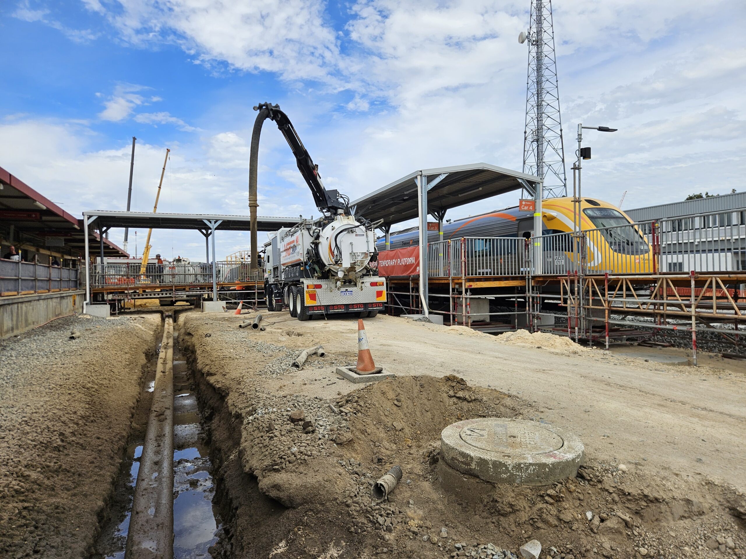 Close-up of the suction hose actively removing dirt and debris from a hole in a commercial area like Perth, WA, Welshpool